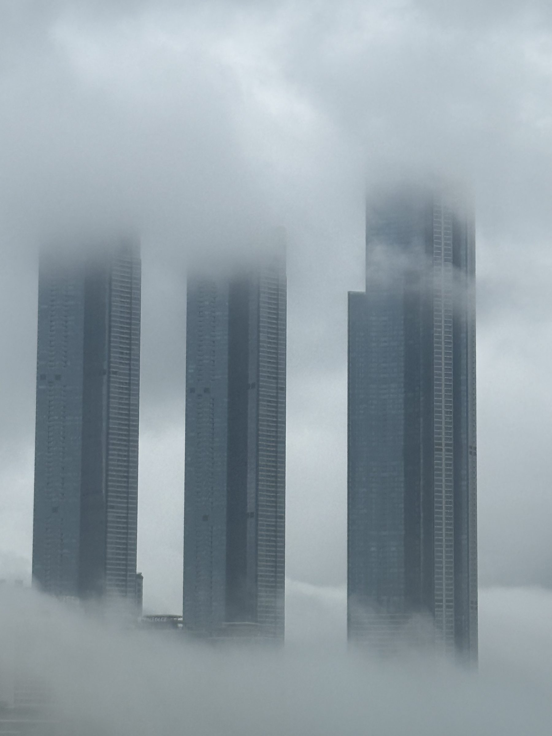 Skyscrapers rising into low cloud